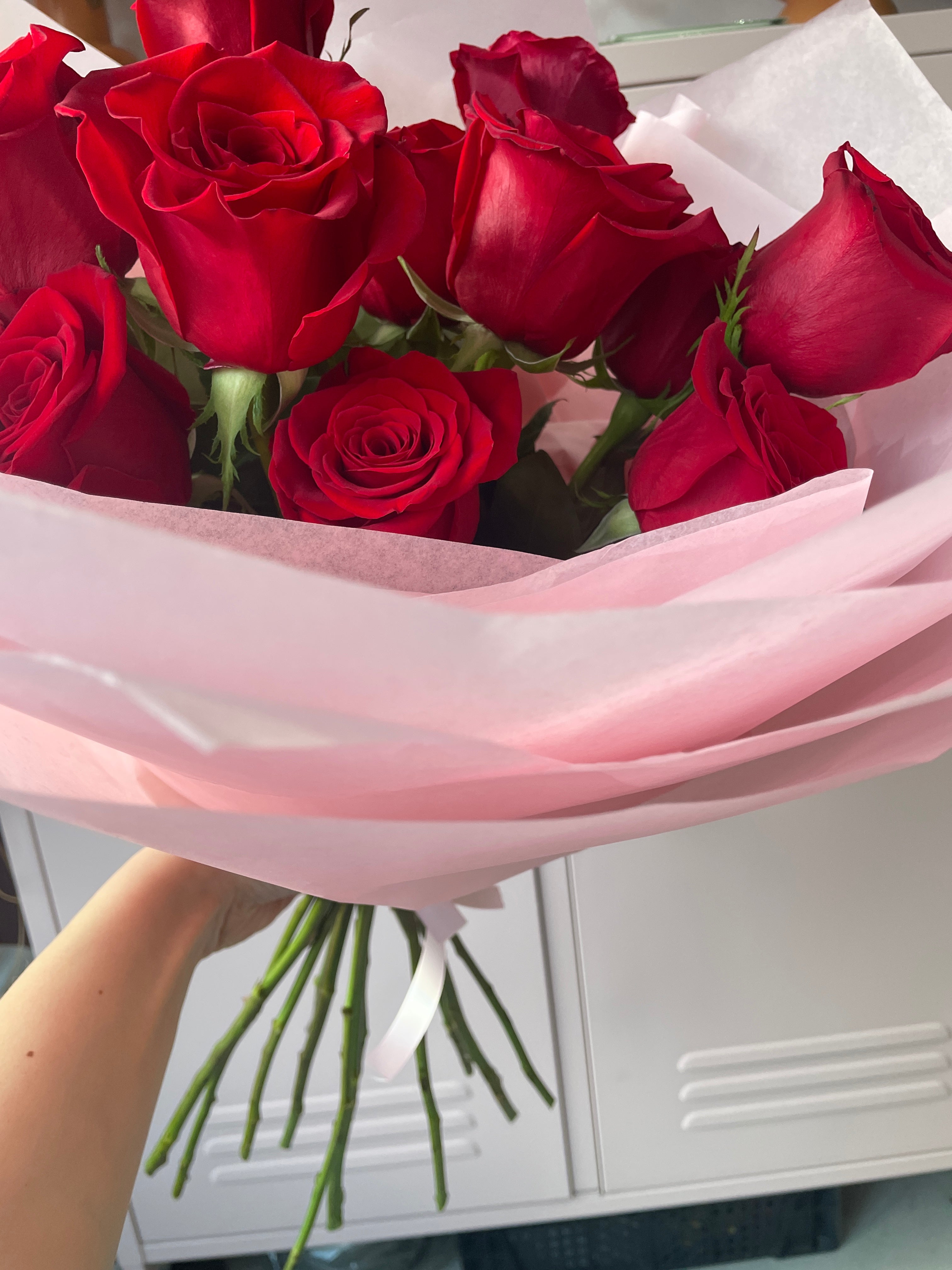 Tissue wrapped Red roses only