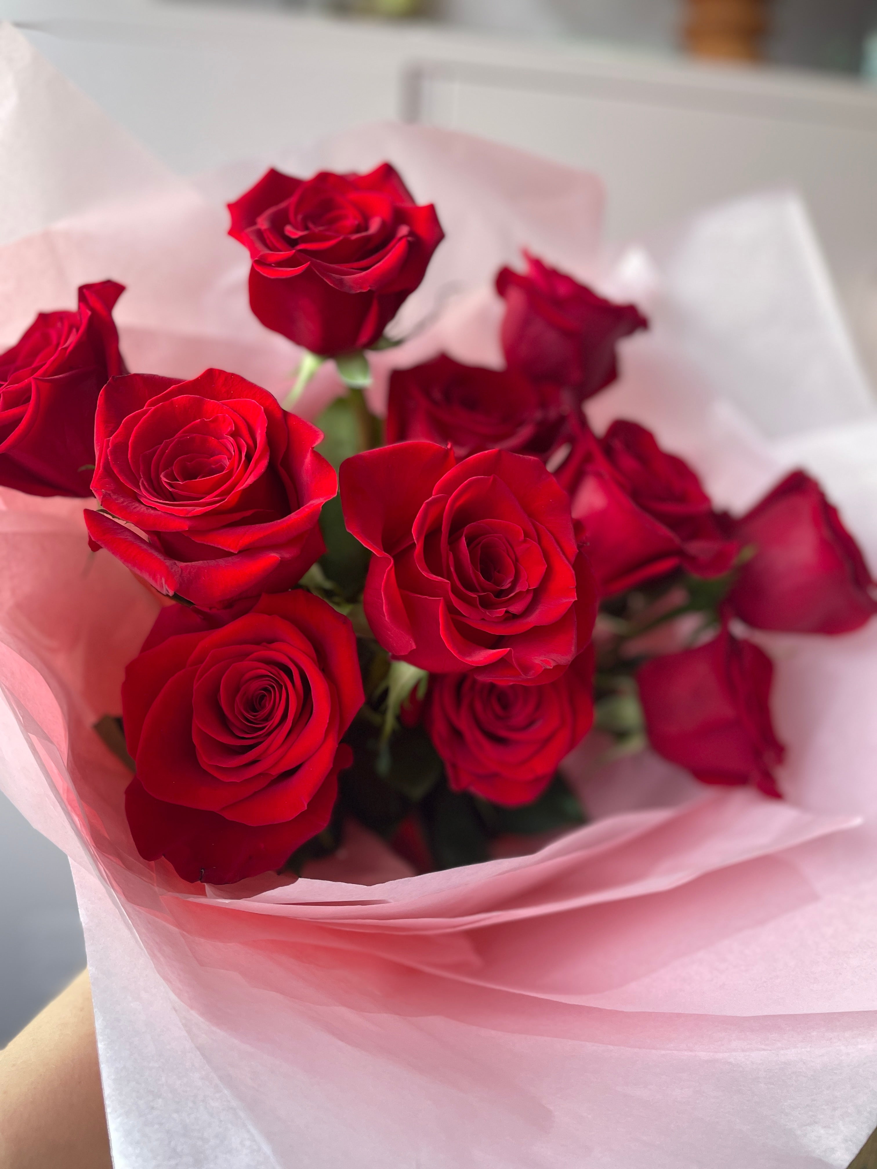 Tissue wrapped Red roses only